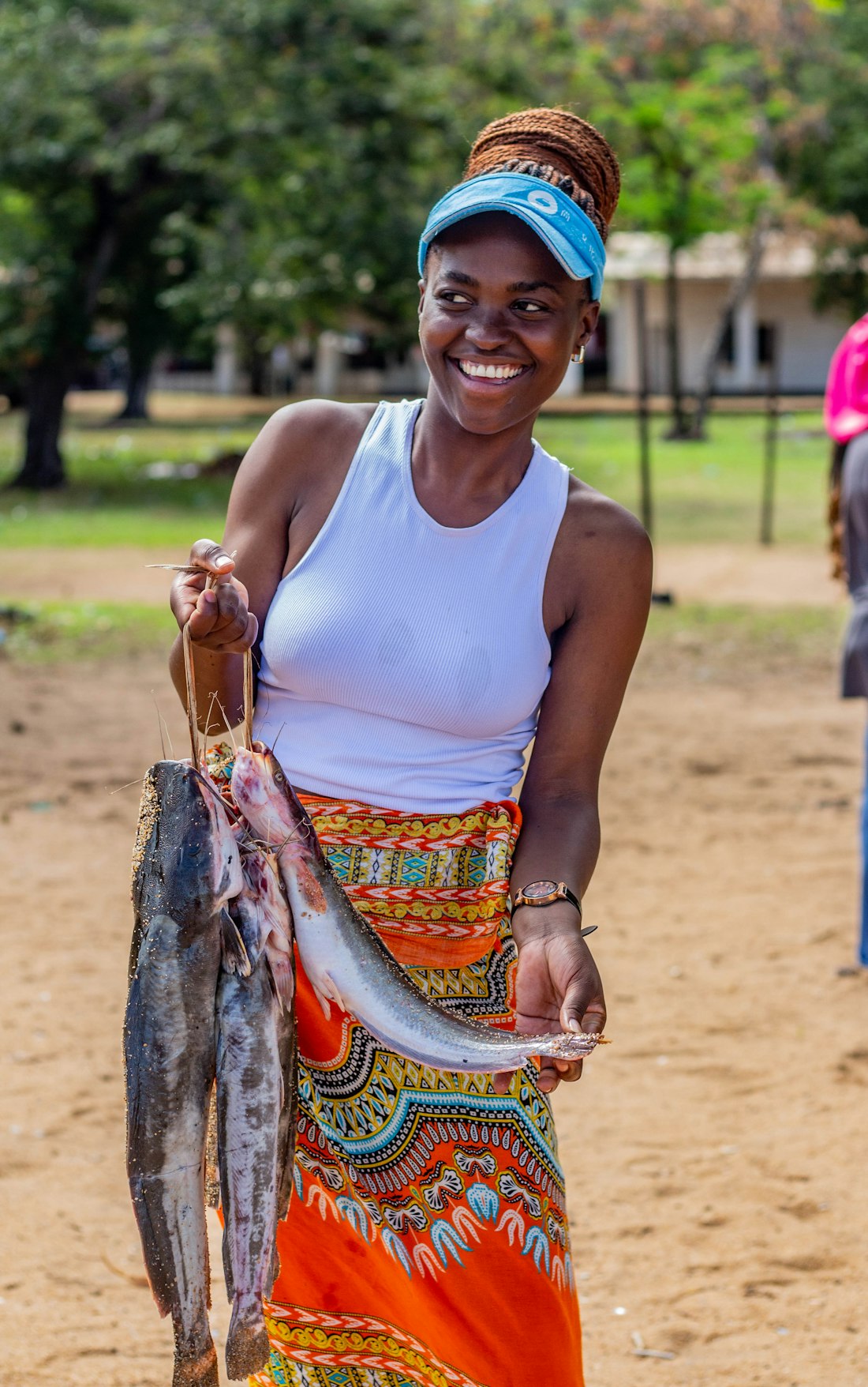 African woman with fresh fish at a market